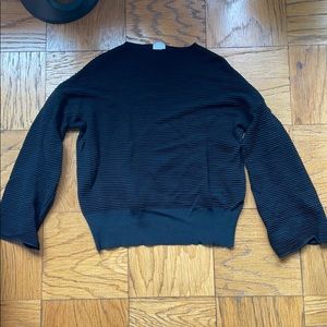 Textured black long sleeve top with flare sleeves